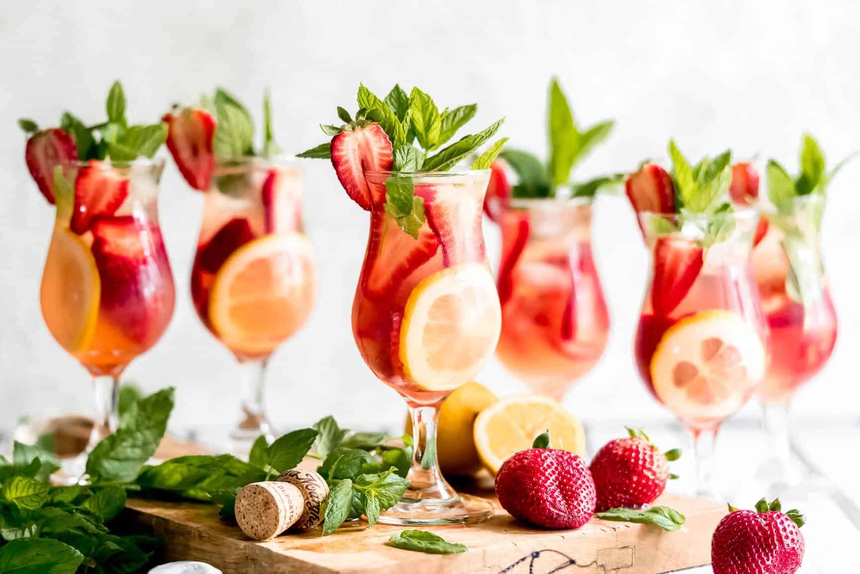 The Best Cocktail of Summer; Sparkling Strawberry Rosé Wine Sangria garnished with mint and lemon.