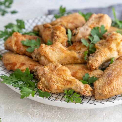 Crispy Air Fryer Chicken Wings Recipe - Shown on two racks in the air fryer  oven