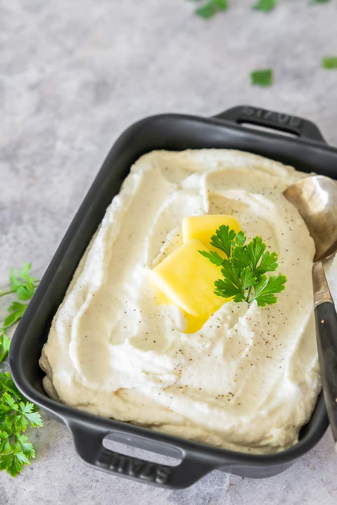 The Best Keto Mashed Cauliflower is my favorite way to conquer comfort food cravings when following a low-carb diet. My secret is using frozen cauliflower and cream cheese for the ultimate creamy and delicious side dish, that no one will guess isn't potatoes! 