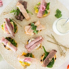 crostini sandwich bites on a decorative tray