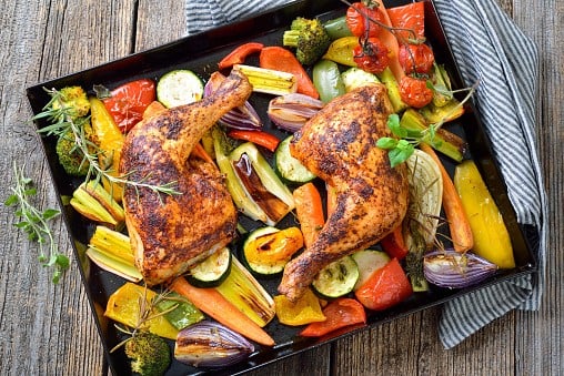 Oven roasted chicken legs with vegetables