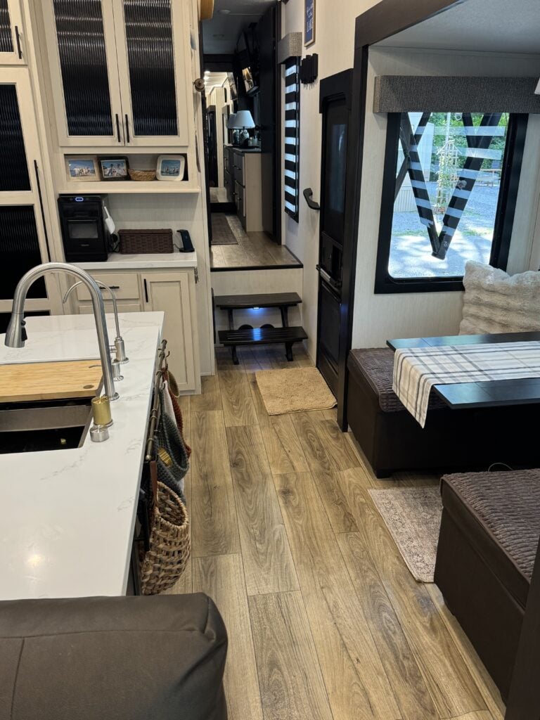 an rv kitchen and living room with a wood floor