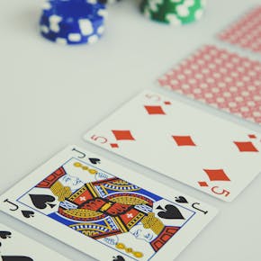 A detailed view of poker cards and chips depicting a strategic gambling setup.
