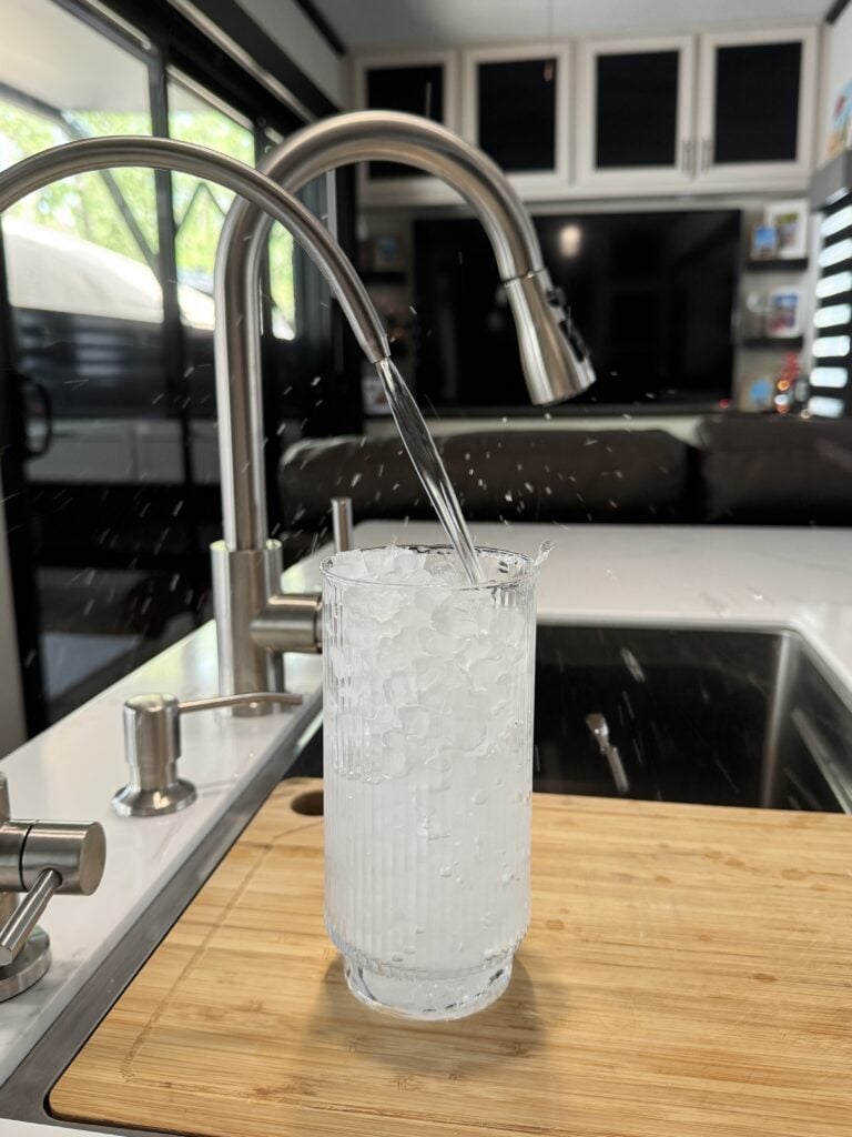 a glass with ice being poured into a glass