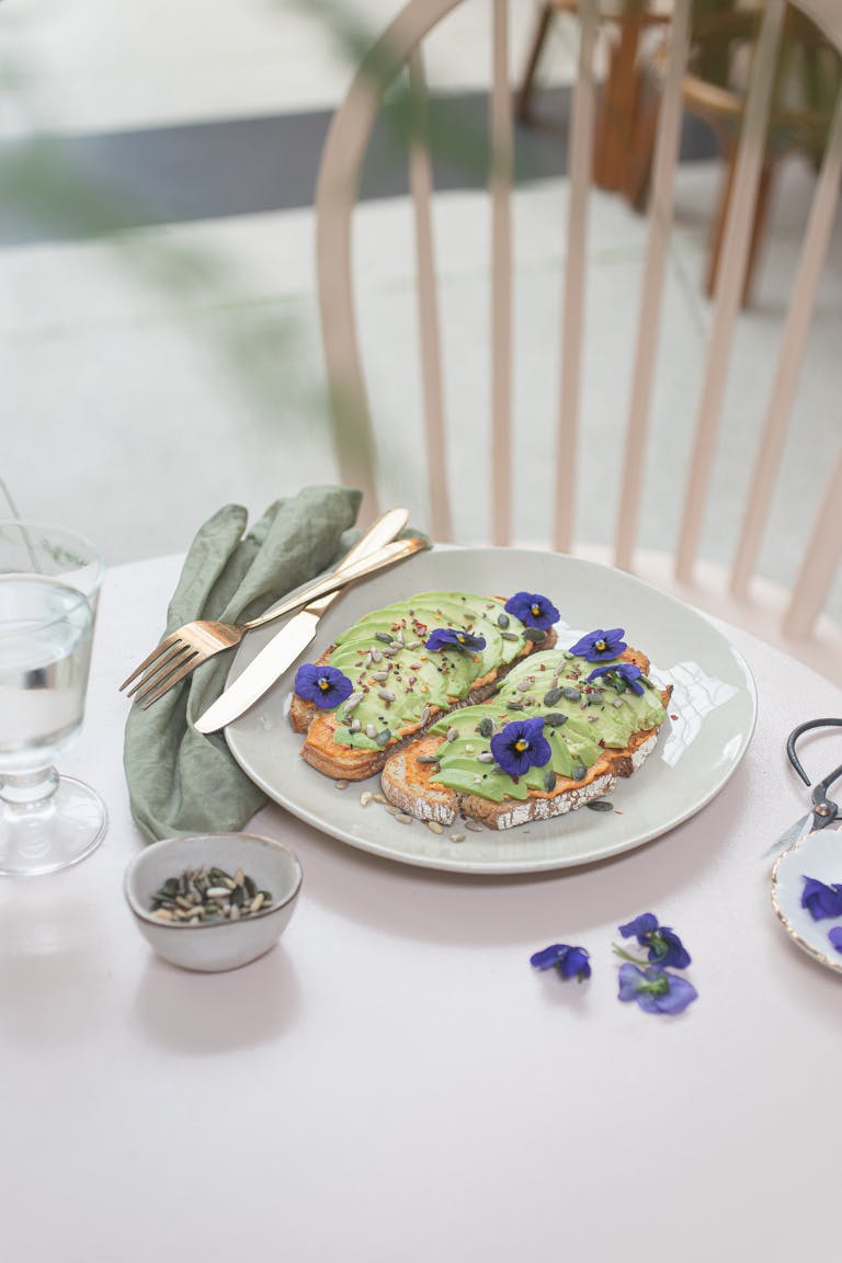 Stylish avocado toast garnished with edible flowers, perfect for brunch.