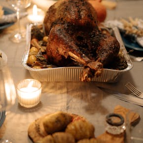 Appetizing roasted turkey on a festive Thanksgiving dining table setting.
