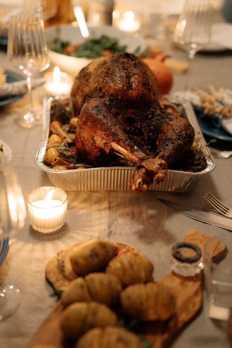 Appetizing roasted turkey on a festive Thanksgiving dining table setting.