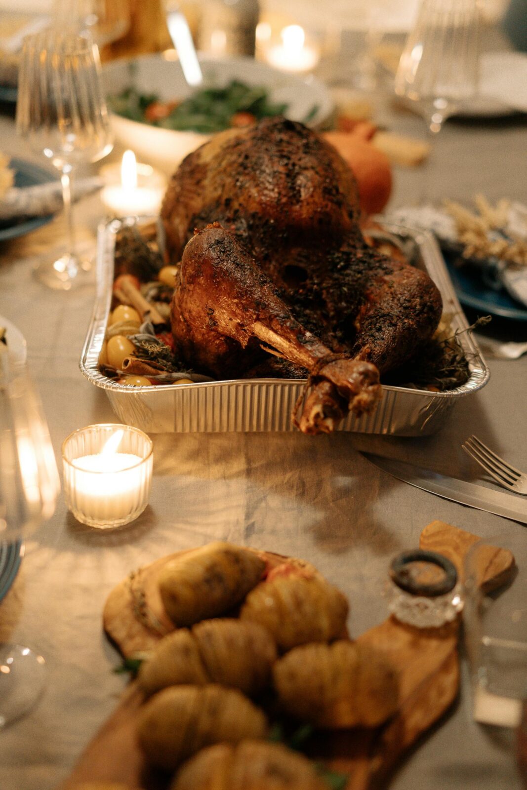 Appetizing roasted turkey on a festive Thanksgiving dining table setting.