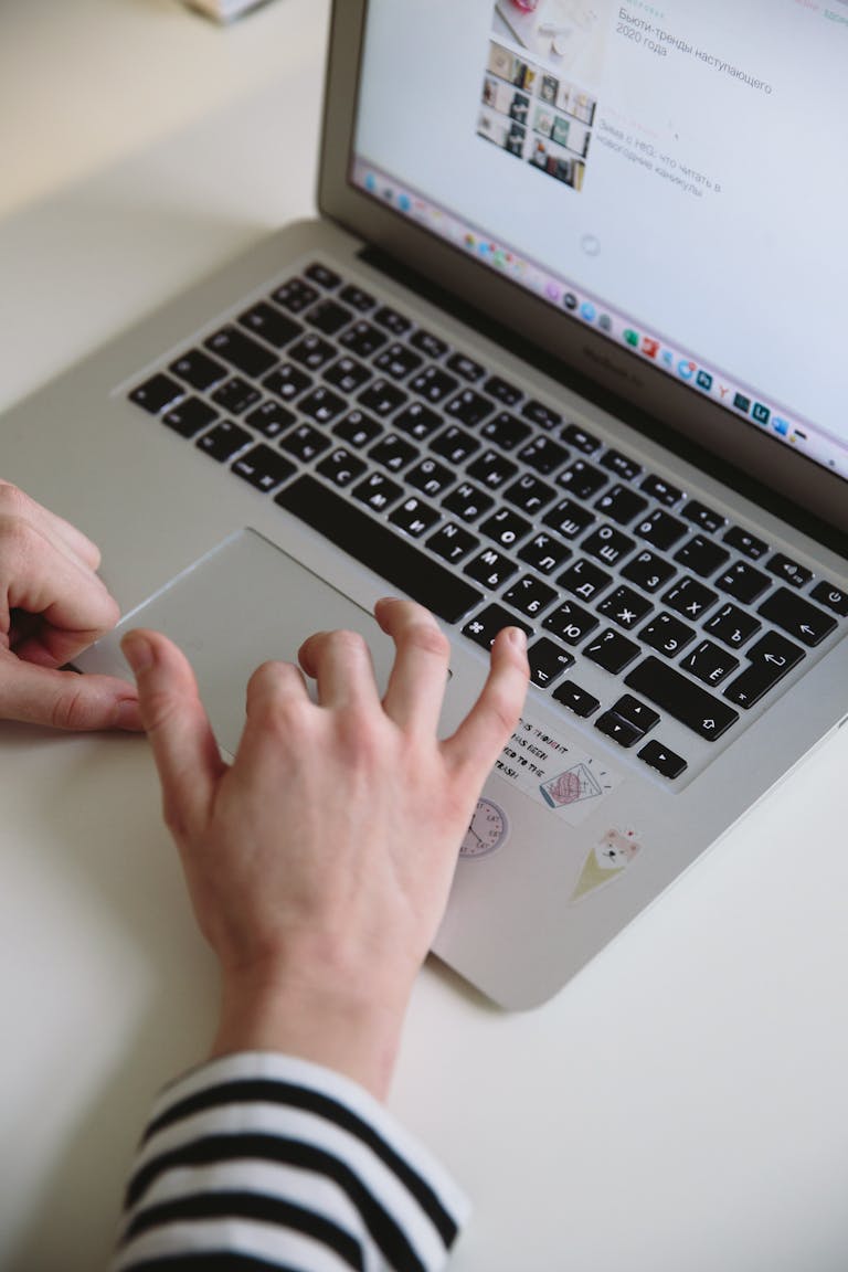 A woman uses a laptop in a home office setting, perfect for remote work and freelance projects.