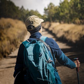 Adventurous hiker on a scenic trail in Puebla, México, embracing nature with hiking gear.