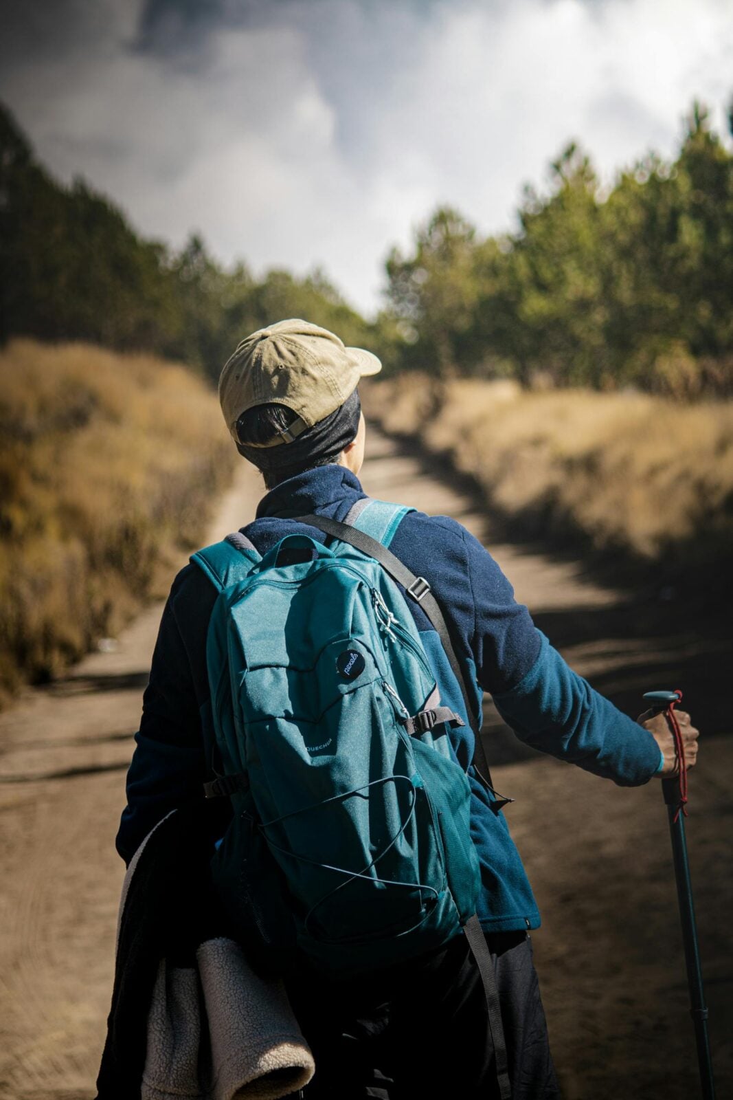 Adventurous hiker on a scenic trail in Puebla, México, embracing nature with hiking gear.