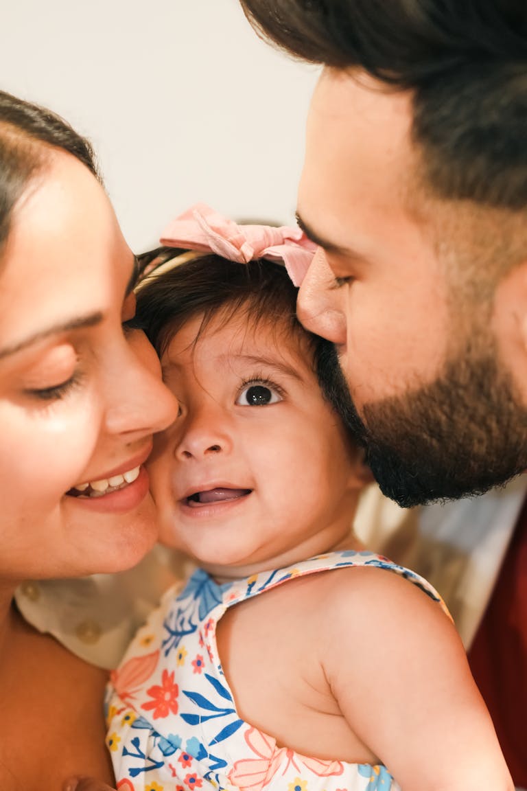 Close-up of a joyful family moment with a baby, capturing love and happiness.