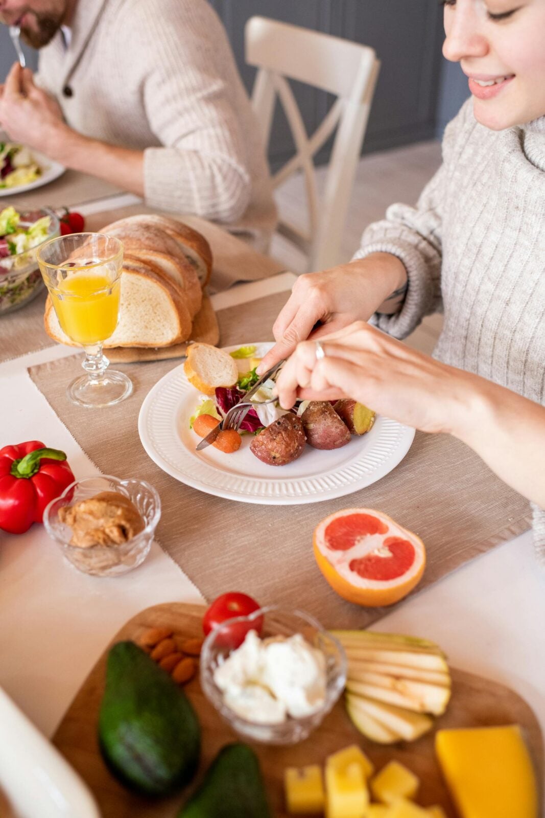 A cozy family breakfast scene with fresh fruits, vegetables, and orange juice.