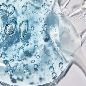 Macro shot of clear cosmetic gel with air bubbles showing texture and clarity.