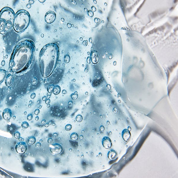 Macro shot of clear cosmetic gel with air bubbles showing texture and clarity.