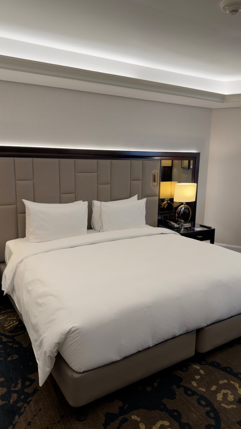 Spacious hotel room featuring a large bed and stylish decor, ideal for travelers seeking comfort.