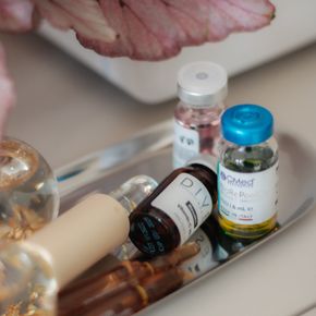 Aesthetic display of skincare products on a tray, perfect for beauty and wellness themes.