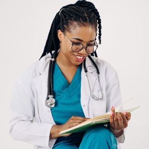 Smiling female doctor with stethoscope reading medical documents.