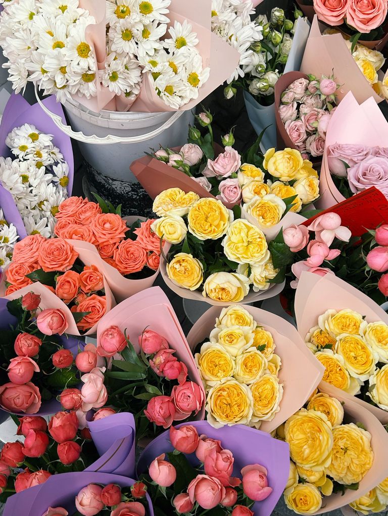 A colorful assortment of flower bouquets including daisies and roses at a market in Azerbaijan.