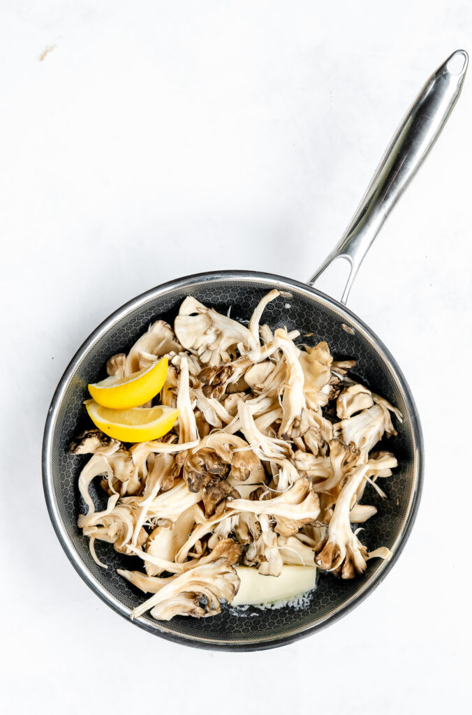 Maitake mushrooms sautéing in butter