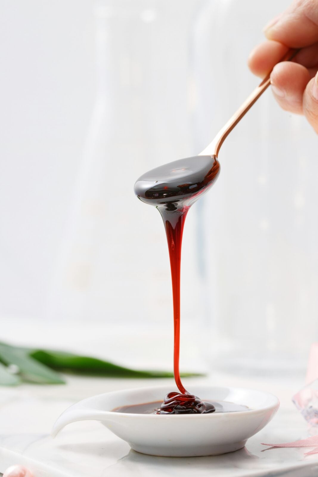 homemade elderberry syrup drippig off a spoon
