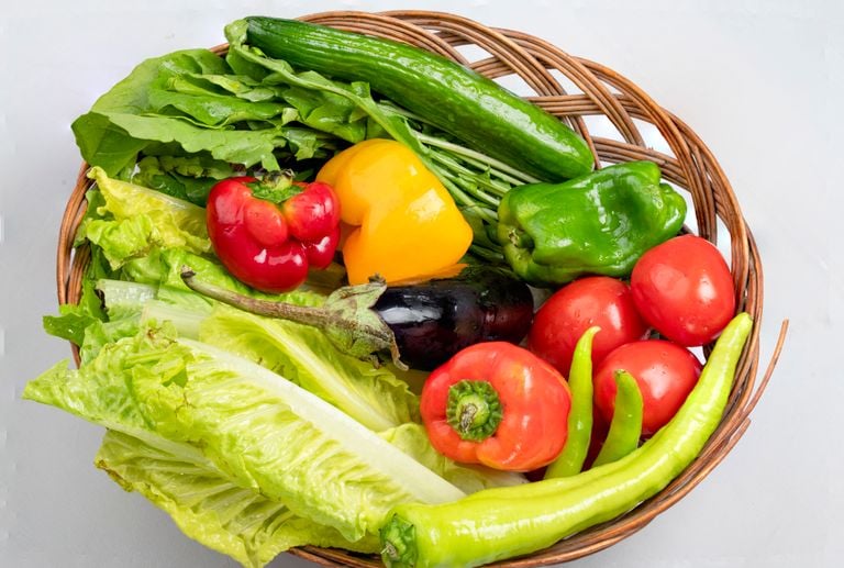 A vibrant assortment of fresh vegetables in a wicker basket. Ideal for healthy eating concepts.