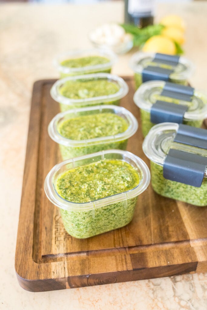 Basil pesto portioned into small freezer containers