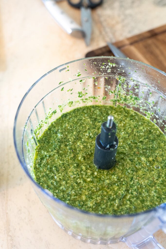 Fresh basil pesto in a food processor bowl