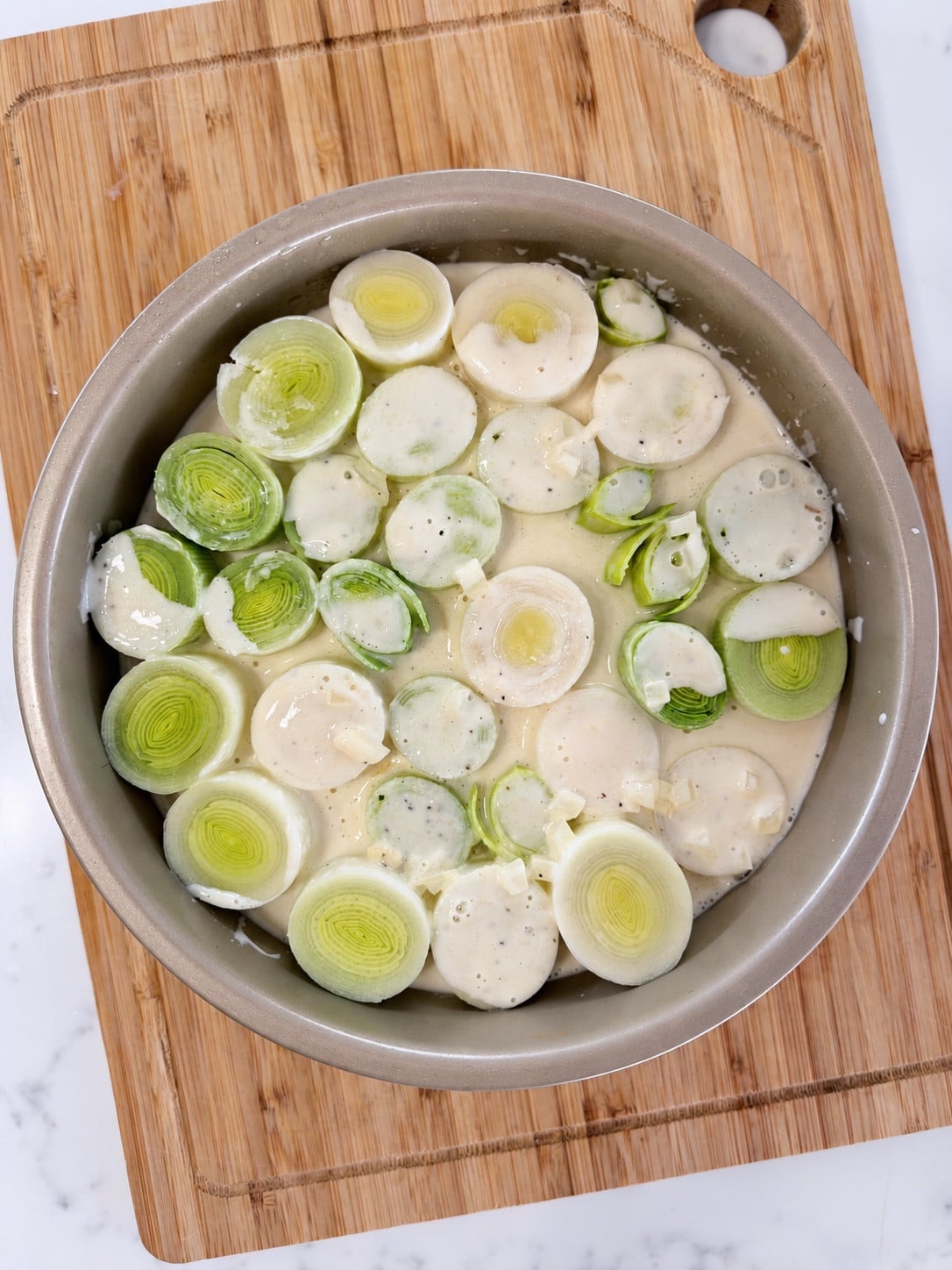 Upright leek rounds covered with creamy Parmesan sauce before air frying