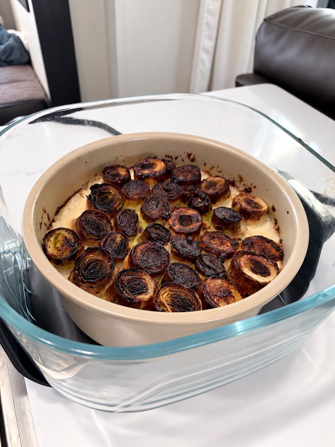 Deeply browned crispy leek tops in bubbling cream sauce before adding Parmesan