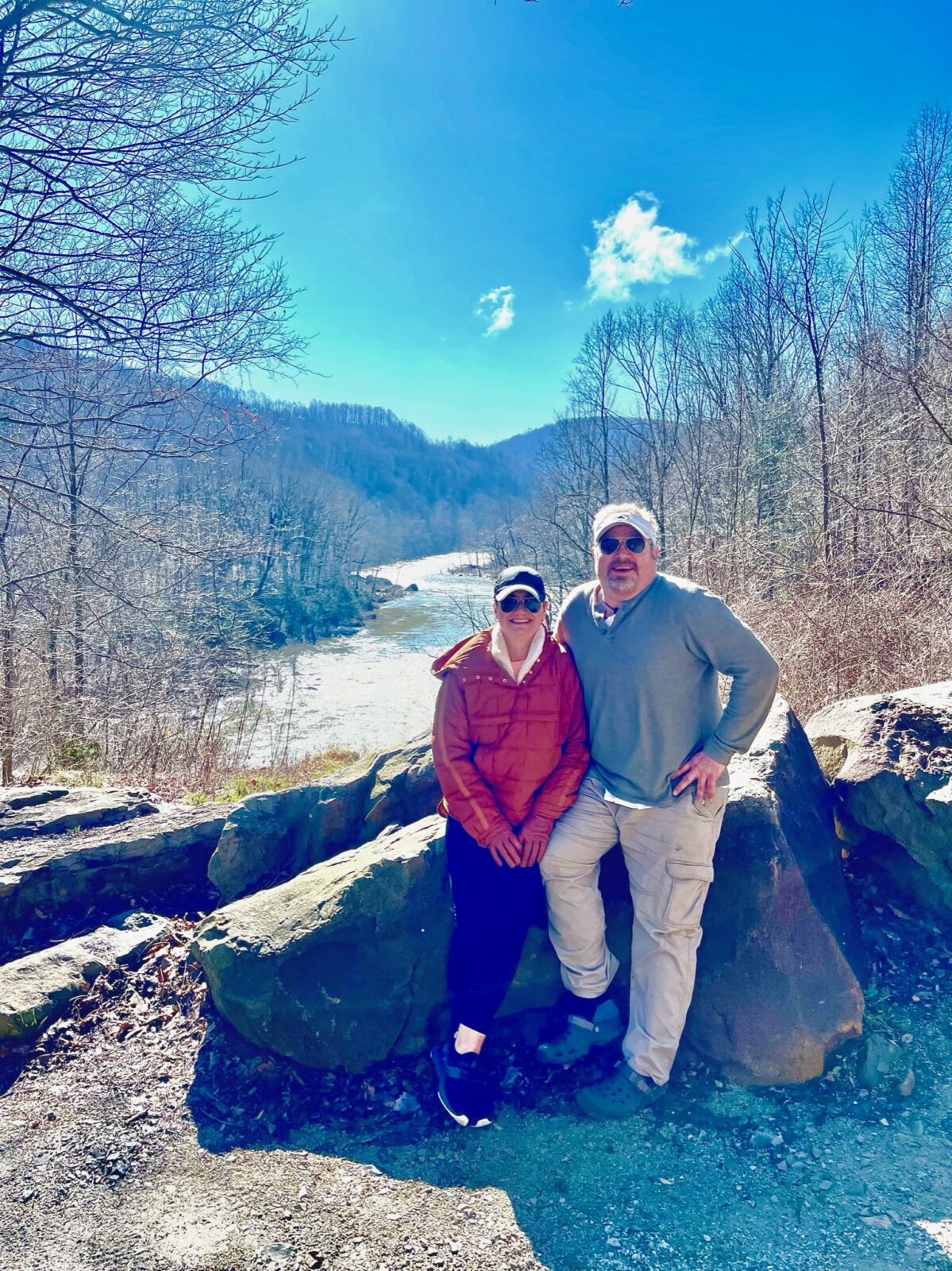 Hayley and Ray together on a rocky overlook above a wooded river