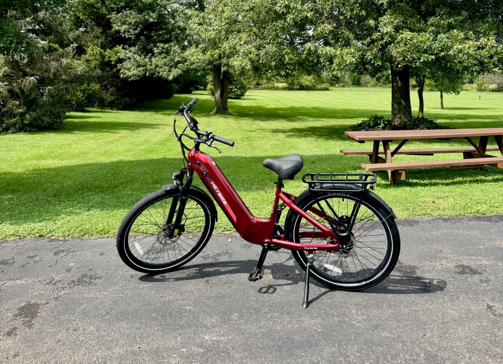 Ruby, my red Heybike Hybrid, beside a picnic area