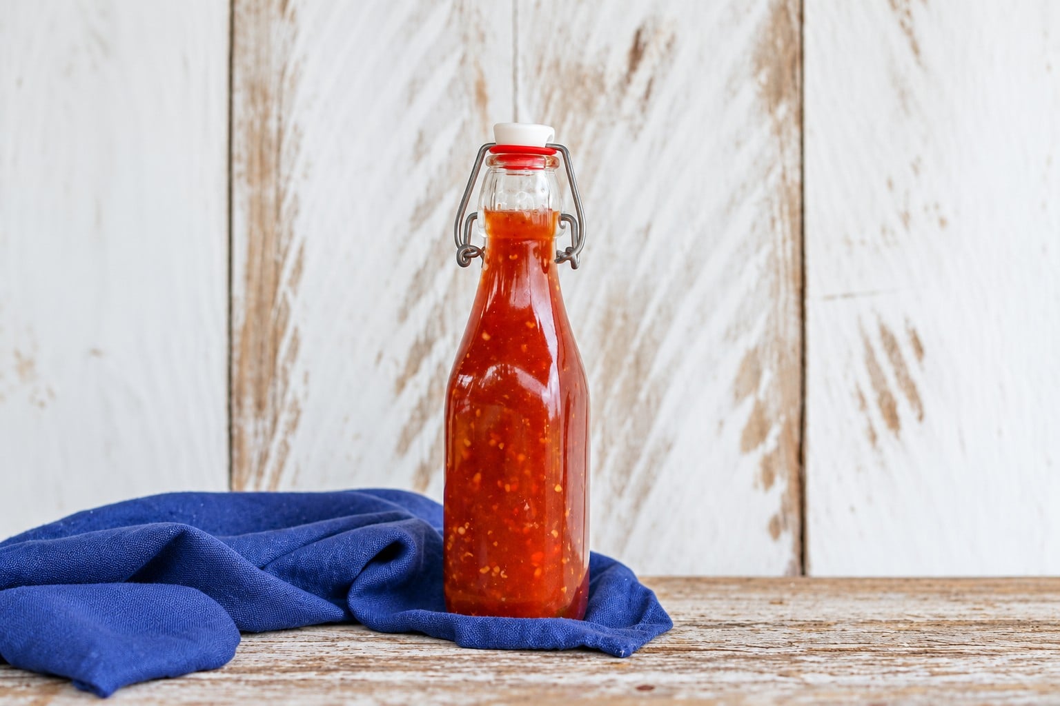 AI-enhanced view of the original sweet chili sauce bottle on blue linen